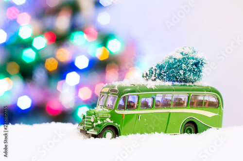 Photo of a green toy bus in the snow