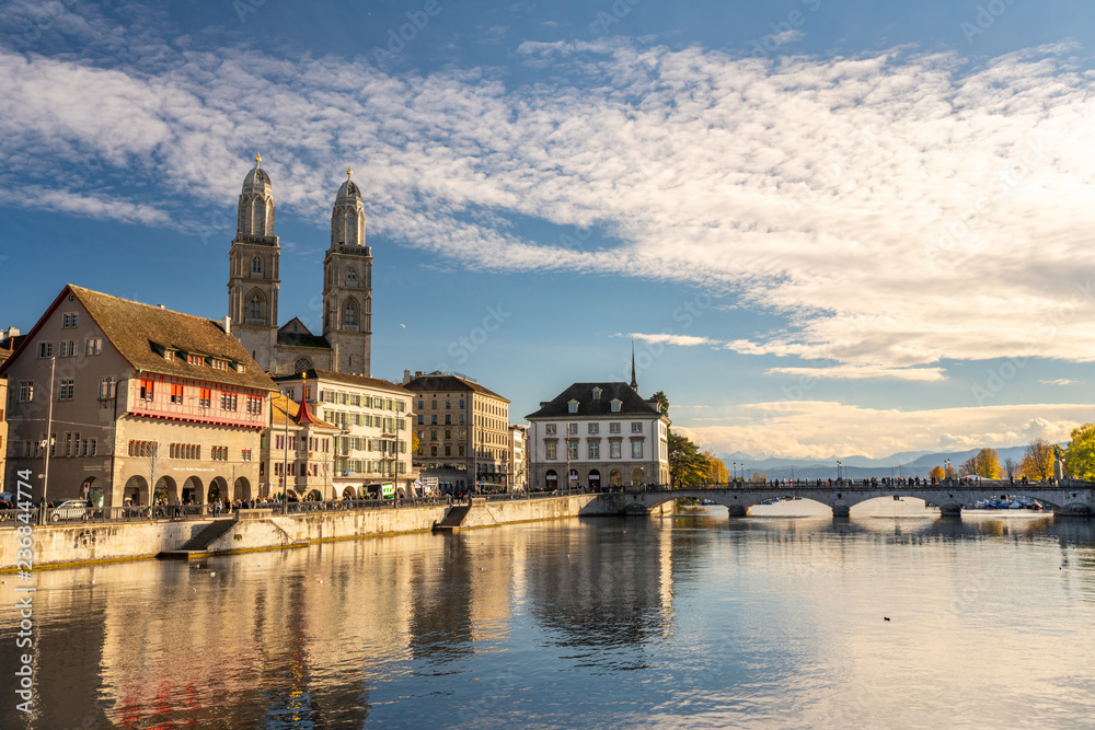 The iconic Grossmünster Church in Zürich with the Limmat River in the foreground