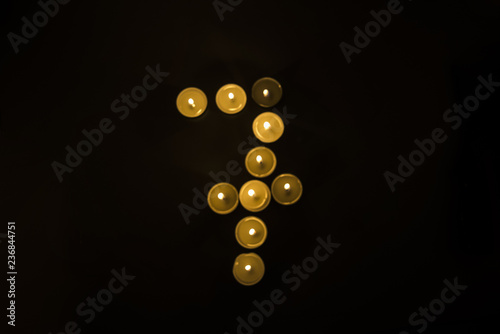 Numbers made from candles on black background.