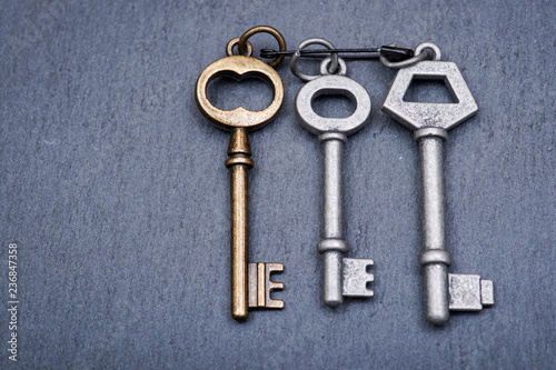 Old vintage metallic keys an natural stone background © bjphotographs