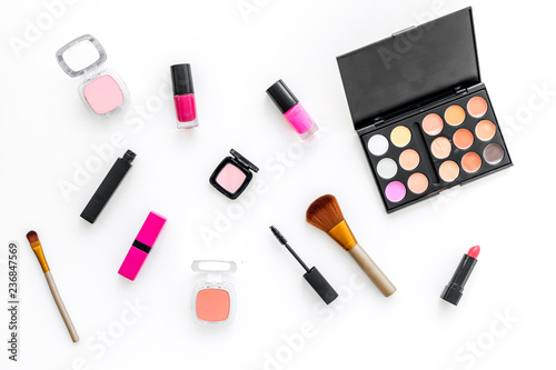 female desk with decorative cosmetics for make up white background top view