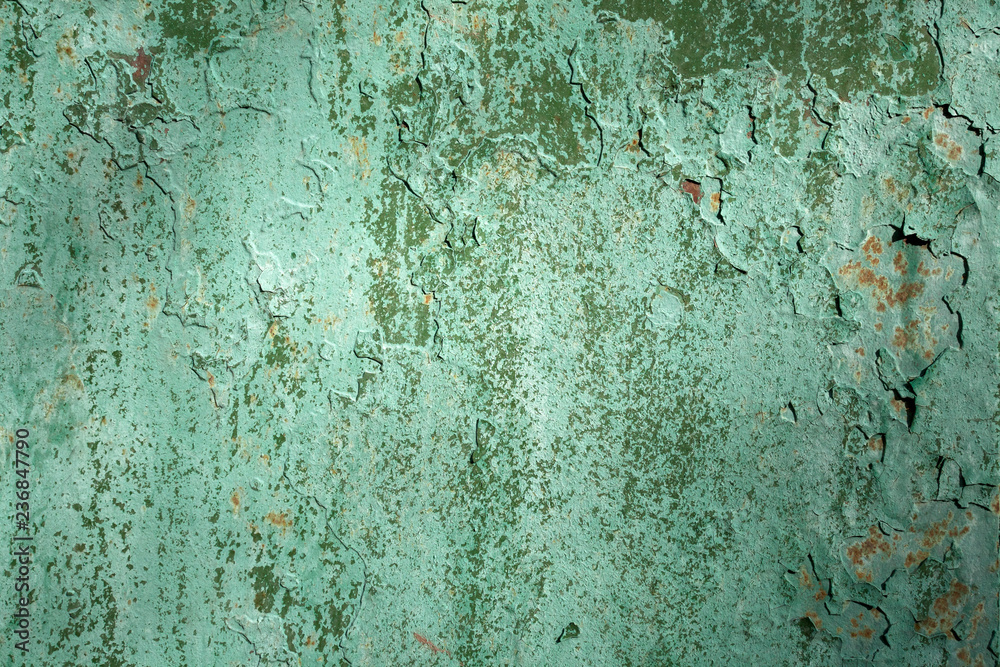 The texture of the old cracked rust wall. Painted in green.
