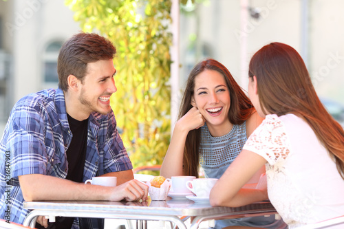 Принти на полотні Three happy friends talking in a coffee shop