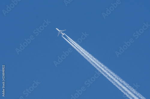 White aircraft three engines aviation airport contrail clouds.