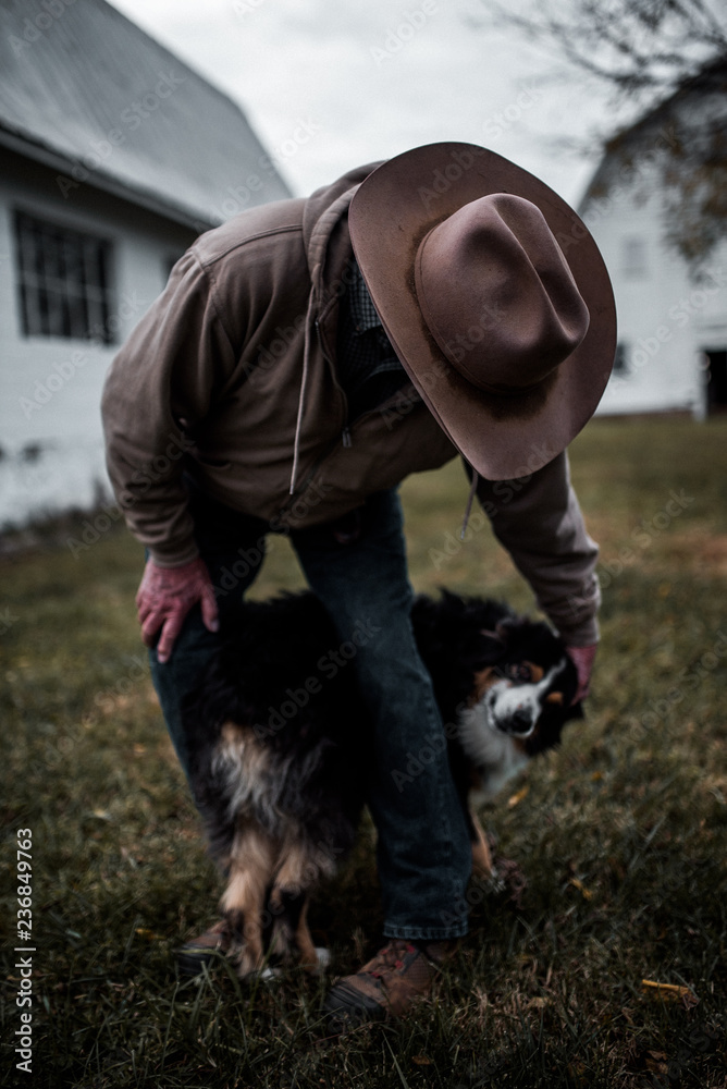 Cowboy pets farm dog