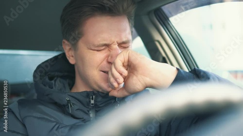 young man crying in the car. depression