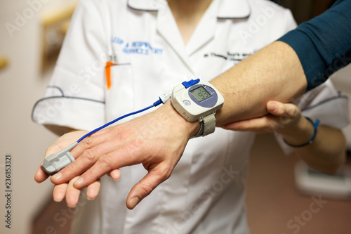 A nurse uses a pulse oximeter to monitor a patients oxygen saturation
