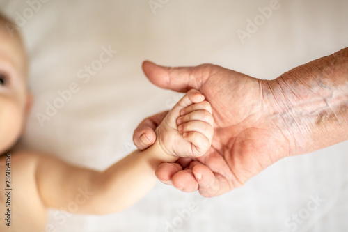 hands of young great-grandson and old great-grandmother. Beautiful conceptual image of old age support. selective focus