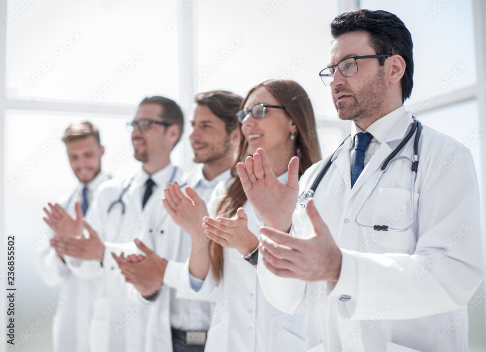 group of doctors applauds, standing in the hospital group of doctors applauds, standing in the hospital