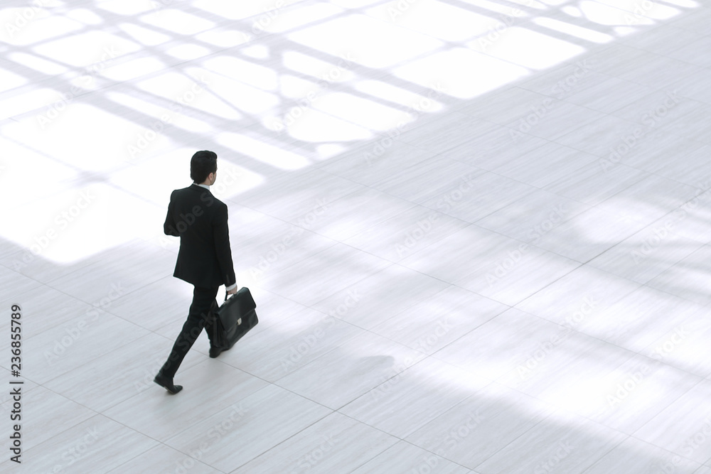 © ASDF - top view from afar.Executive businessman with portfolio