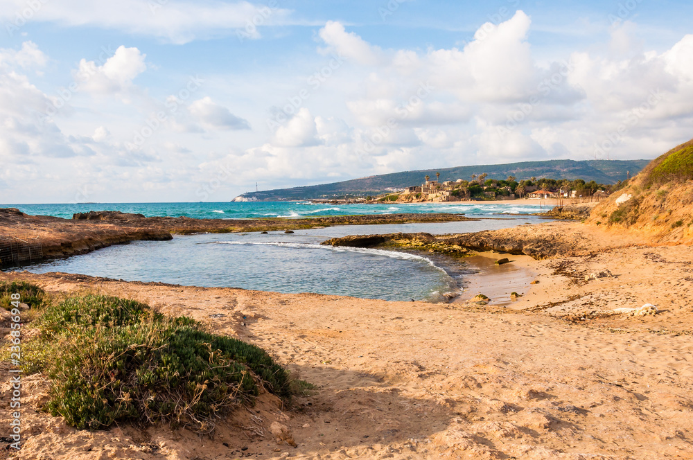Wild beach with cliffs and rocks inside the Mediterranean Sea in North Israel near Rosh Hanikra