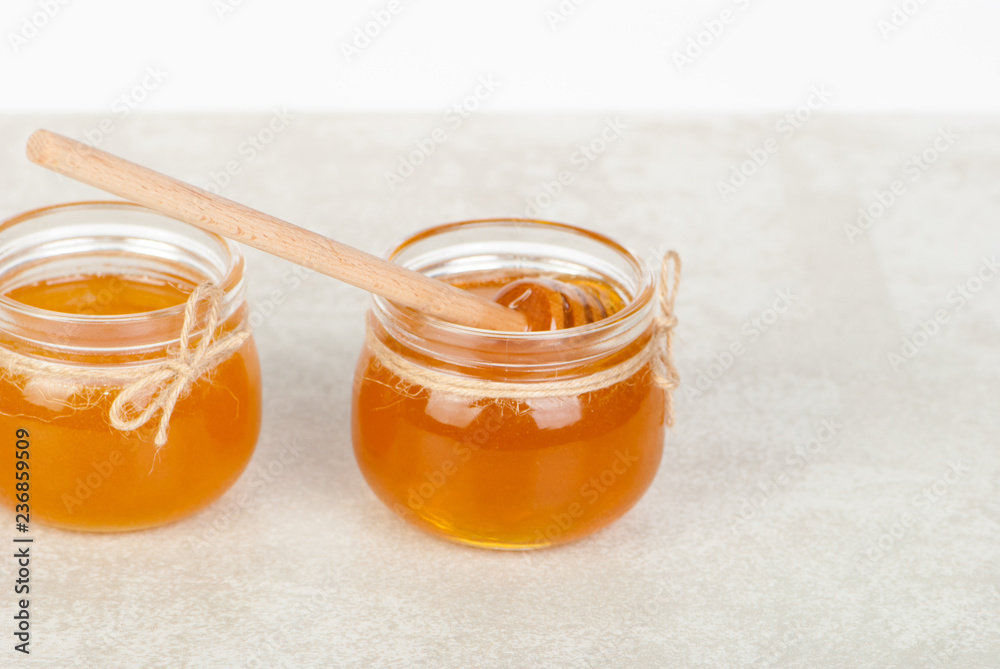 honey in jars on white table honey in jars on white table