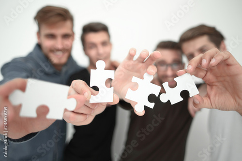 group of young people with puzzle pieces