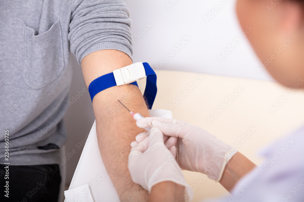 Doctor Injecting Syringe In Patient's Arm Doctor Injecting Syringe In Patient's Arm