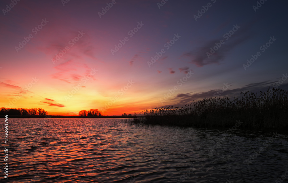 Colorful sunset over sea. Red and orange sky. A long exposure