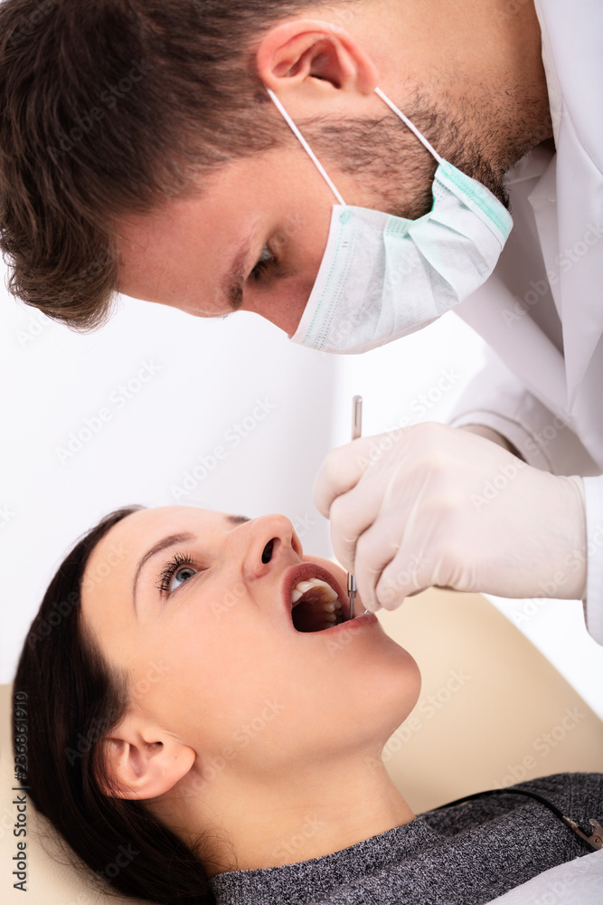 Dentist Examining Woman's Teeth