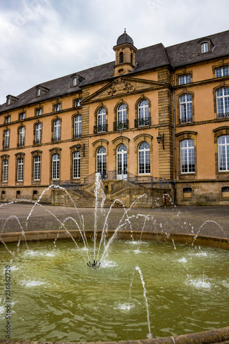 Benedictine Abbey of Echternach, the oldest town in Luxembourg, exterior view, a fountain in the foreground