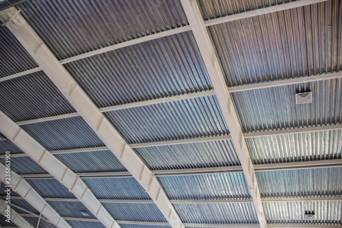 Industrial corrugated metal ceiling structure with metal truss frame