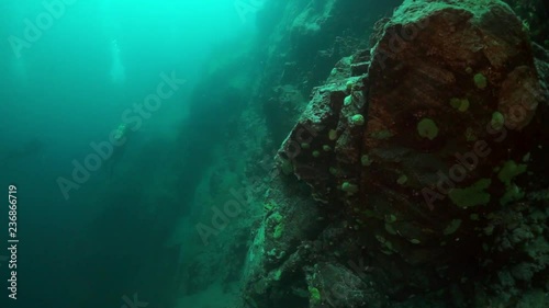 Wallpaper Mural Silhouette of professional diver near stones under water in Lake Baikal. Torontodigital.ca