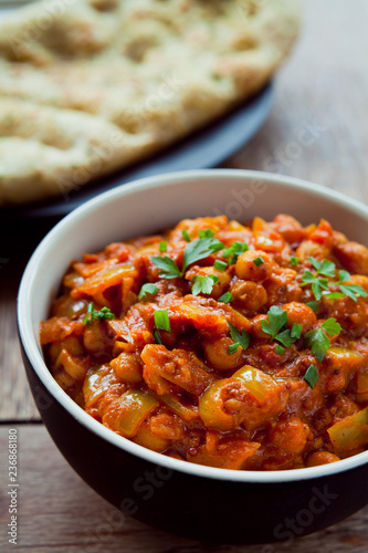 Chickpea Tomato Vegetarian, Vegan, Plant Based Curry  -  Chana Masala with Naan Bread. Chana masala, also known as channay, chole masala, chole or chholay, is a dish originating from the India. photo