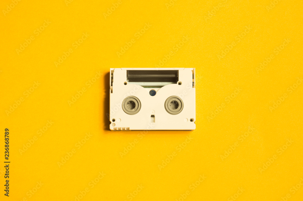 Digital video cassette on yellow background. mini cassette. copy space Digital video cassette on yellow background. mini cassette. copy space