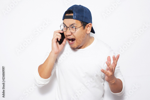 Young Man Getting Bad News on Phone, Shocked and Angry © airdone