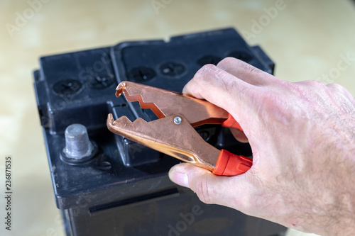 Charging and operating the car battery. Car accessories in the workshop.