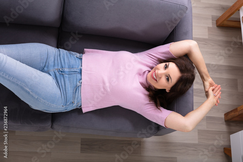 Young Woman Lying On Sofa