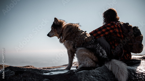 Dog and man on top of mountain