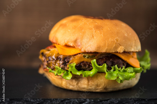 burger with french fries on wooden background
