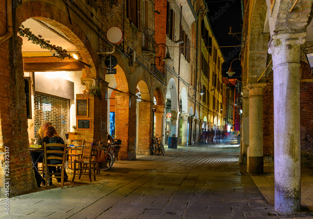 Cozy narrow street at night in Ferrara, Emilia-Romagna, Italy. Ferrara is capital of the Province of Ferrara
