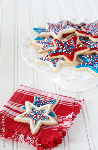 Star sugar cookies decorated with icing and sprikles in red, blue, and white for the 4th of July celebration in America. photo