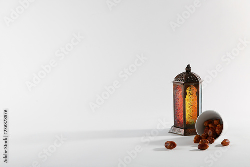 Muslim lamp and dates on white background. Space for text