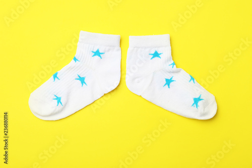 Cute child socks on color background, flat lay
