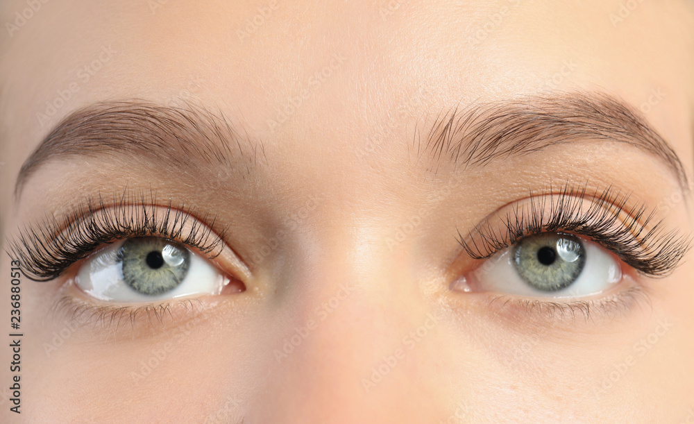 Young woman with beautiful long eyelashes, closeup. Extension procedure Young woman with beautiful long eyelashes, closeup. Extension procedure