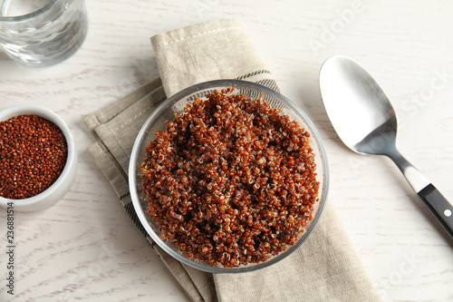 Cooked red quinoa in bowl on table, top view