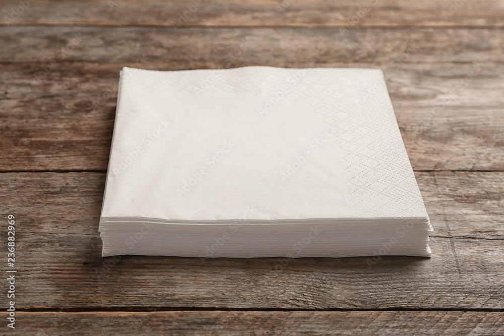 Fototapeta premium Clean napkins on wooden background. Personal hygiene