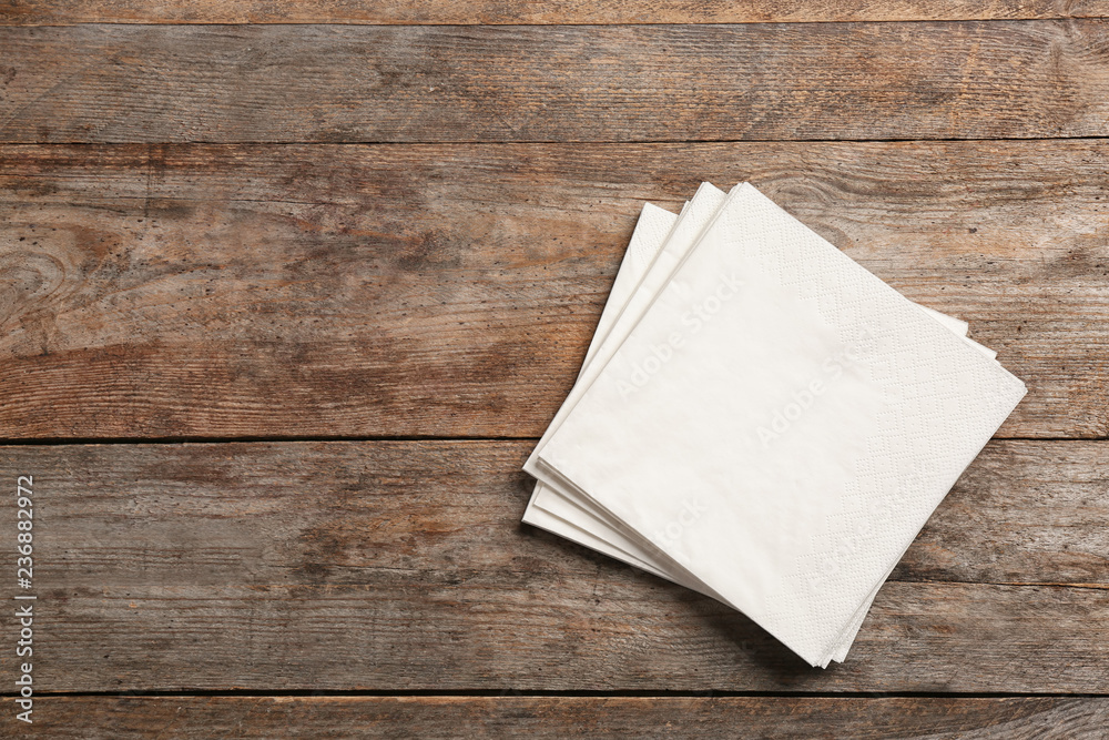 Clean napkins on wooden background, top view with space for text - obrazy, fototapety, plakaty 