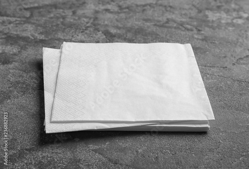 Clean napkins on grey background. Personal hygiene
