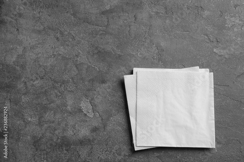 Fototapeta Naklejka Na Ścianę i Meble -  Clean napkins on grey background, top view with space for text