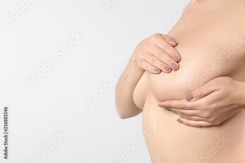 Wallpaper Mural Woman checking her breast and space for text on white background, closeup Torontodigital.ca