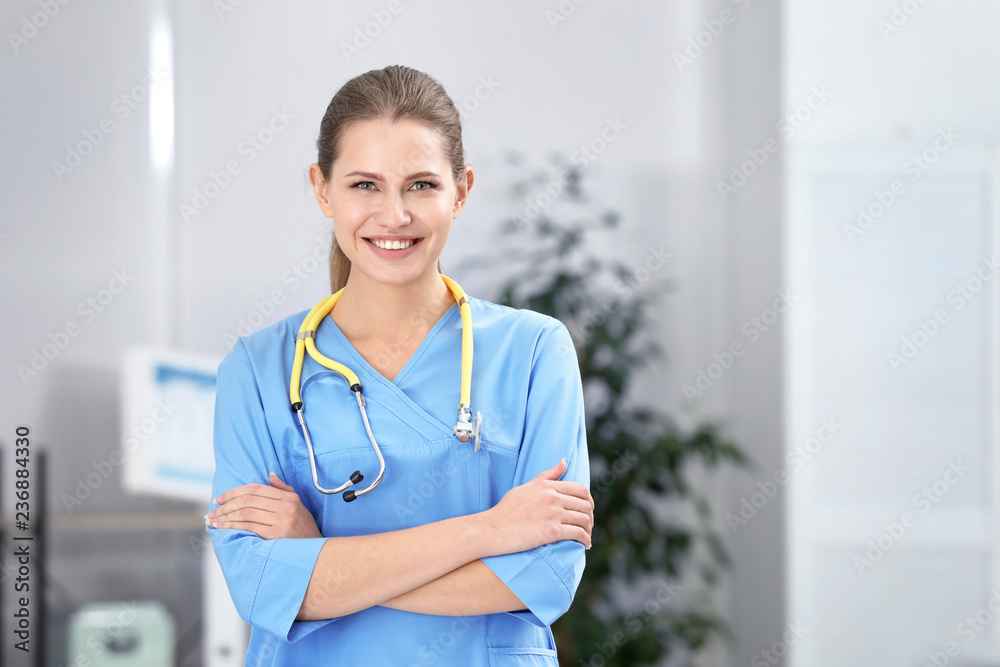 Portrait of young medical assistant with stethoscope in hospital. Space for text Portrait of young medical assistant with stethoscope in hospital. Space for text