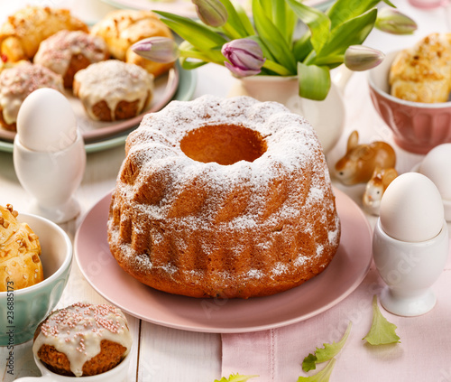 Easter yeast cake sprinkled with powdered sugar on the holiday table. Traditional polish easter dessert