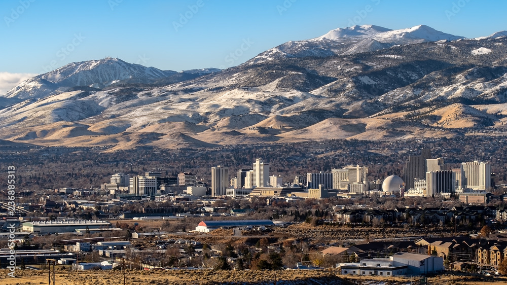 City of Reno Nevada, cityscape in the early winter with snow covered mountains, casinos and hotels.