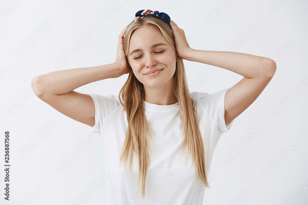 Feeling pretty and fresh today, lucky to have clear skin. Carefree happy and tender young european woman in headband, closing eyes and smiling from happiness, holding hands on head joyfully Feeling pretty and fresh today, lucky to have clear skin. Carefree happy and tender young european woman in headband, closing eyes and smiling from happiness, holding hands on head joyfully