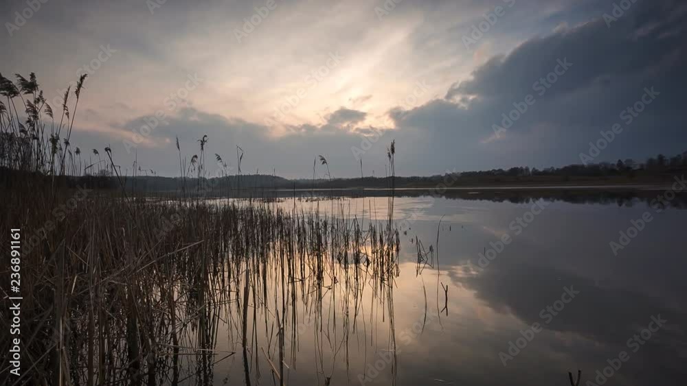 Sunset time-lapse over lake. Calm cloudy spring sunset. Sunset time-lapse over lake. Calm cloudy spring sunset.