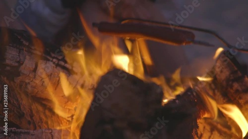 Hot dogs over a beach campfire