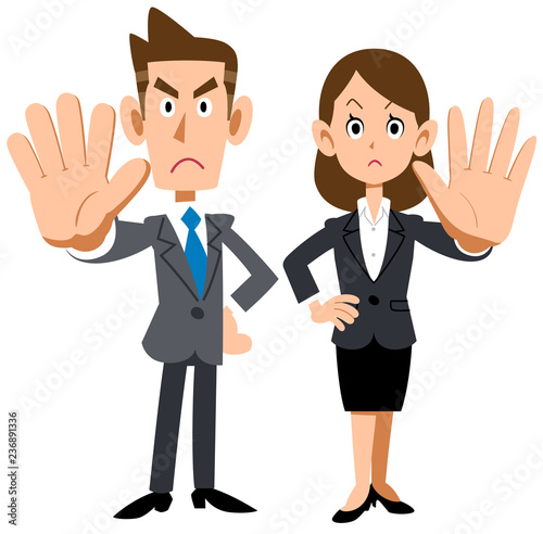 拒否のポーズをする若い会社員の男女
