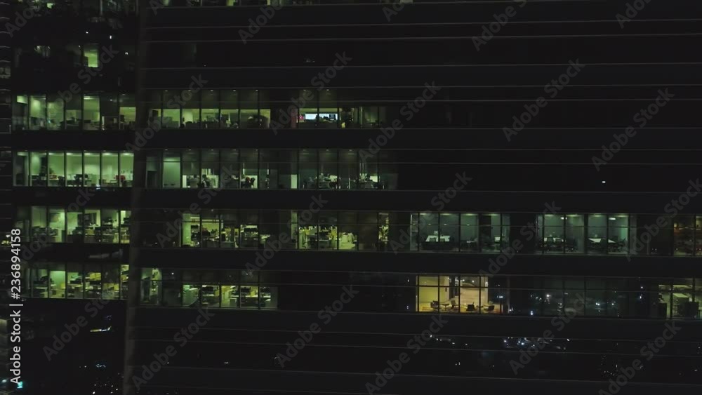 Frontal view of the night facade of building with a lot of lighted ...