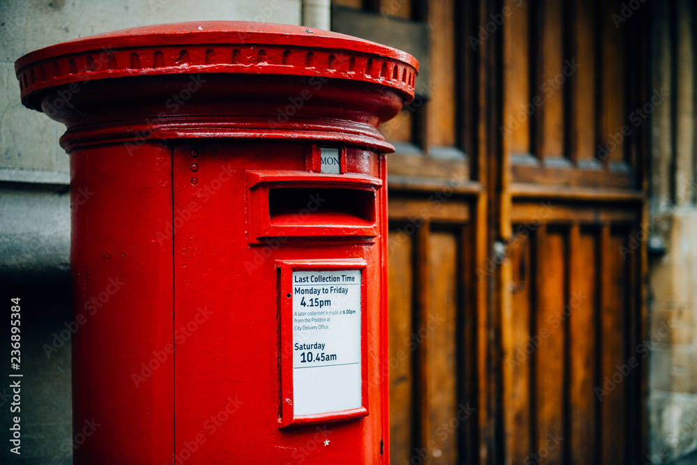 Iconic red British mailbox in a city Iconic red British mailbox in a city